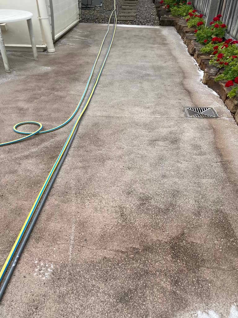 Stained concrete courtyard before cleaning