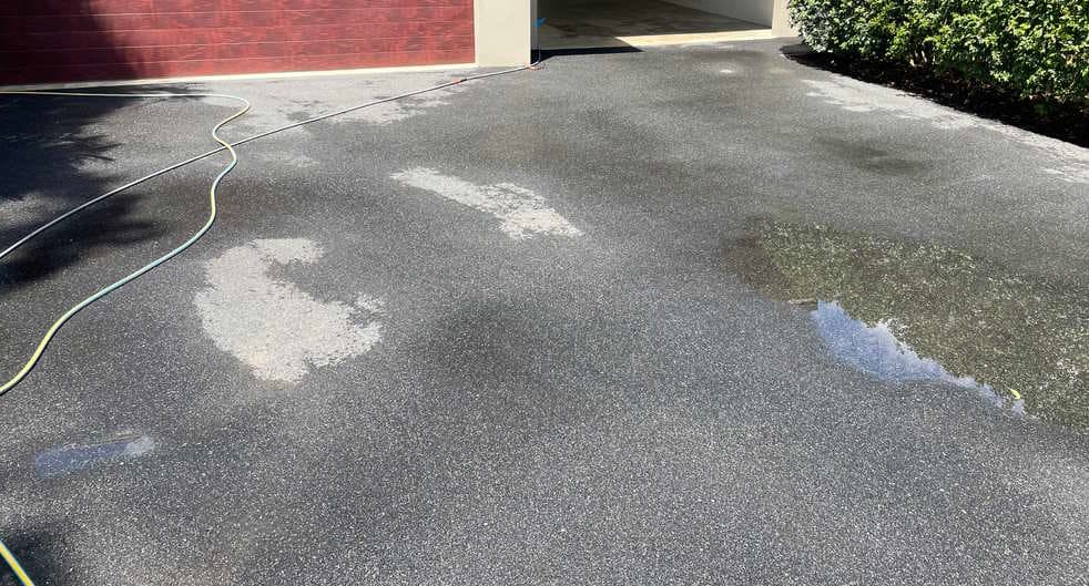 Driveway after pressure cleaning, staining mostly removed