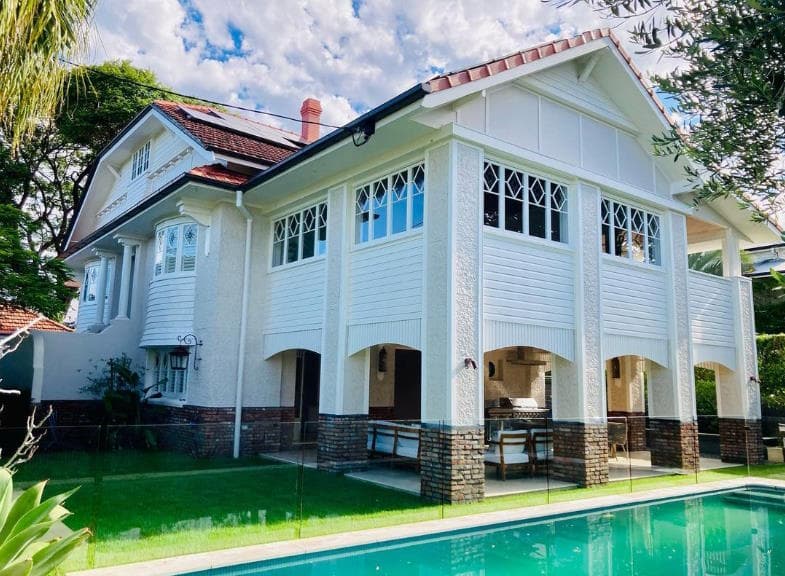 Large Queenslander-style home exterior with a pool