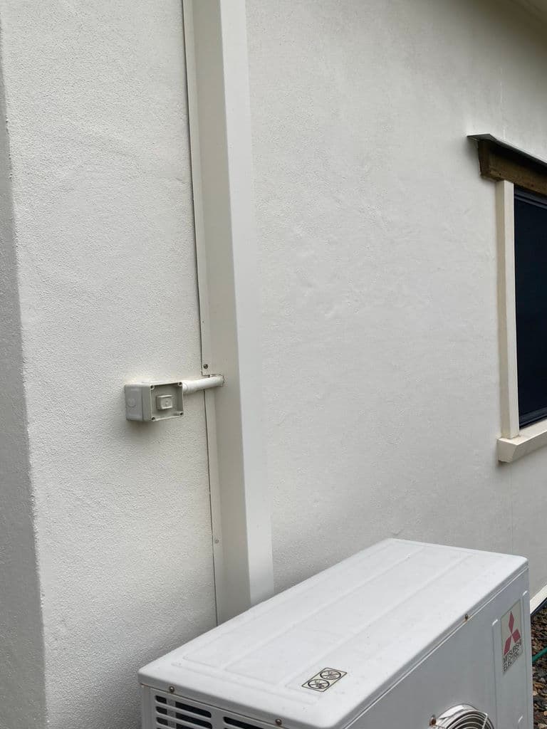 Rendered exterior wall after cleaning, clean white finish