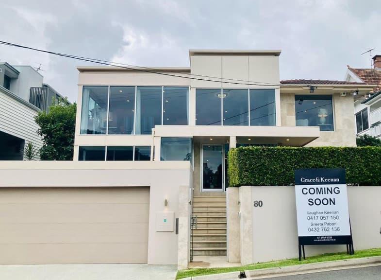 Brisbane home exterior with a real estate for-sale sign